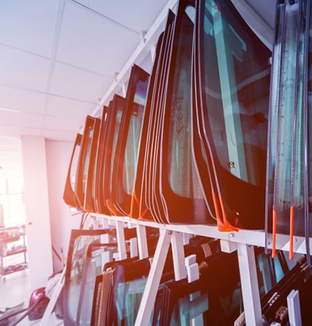 Many windshields stored on shelves
