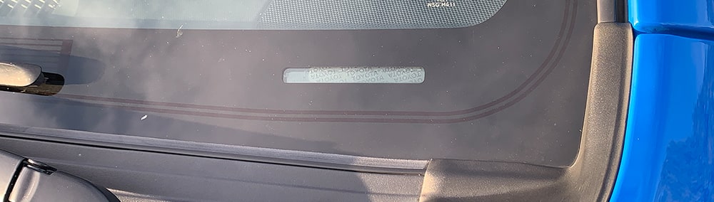 Blue Toyota SUV windshield showing VIN