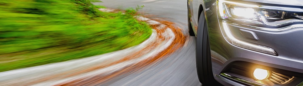 Car with headlights turned on at dusk