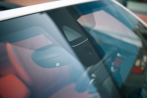 Close up of water light sensor on windshield