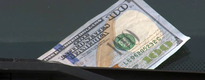 Fake money on a windshield