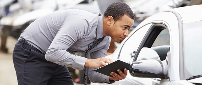 Man inspecting car windshield
