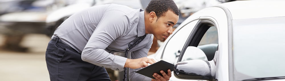 Man inspecting car windshield
