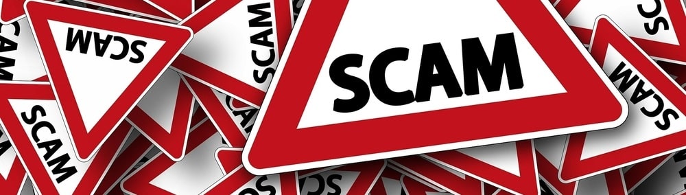 Pile of street signs with SCAM text on them