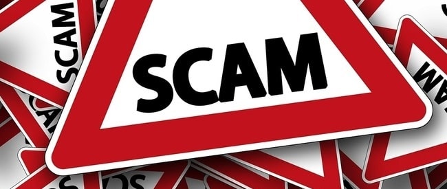 Pile of street signs with SCAM text on them