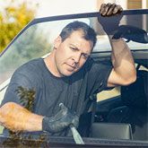 Mobile technician removing old windshield